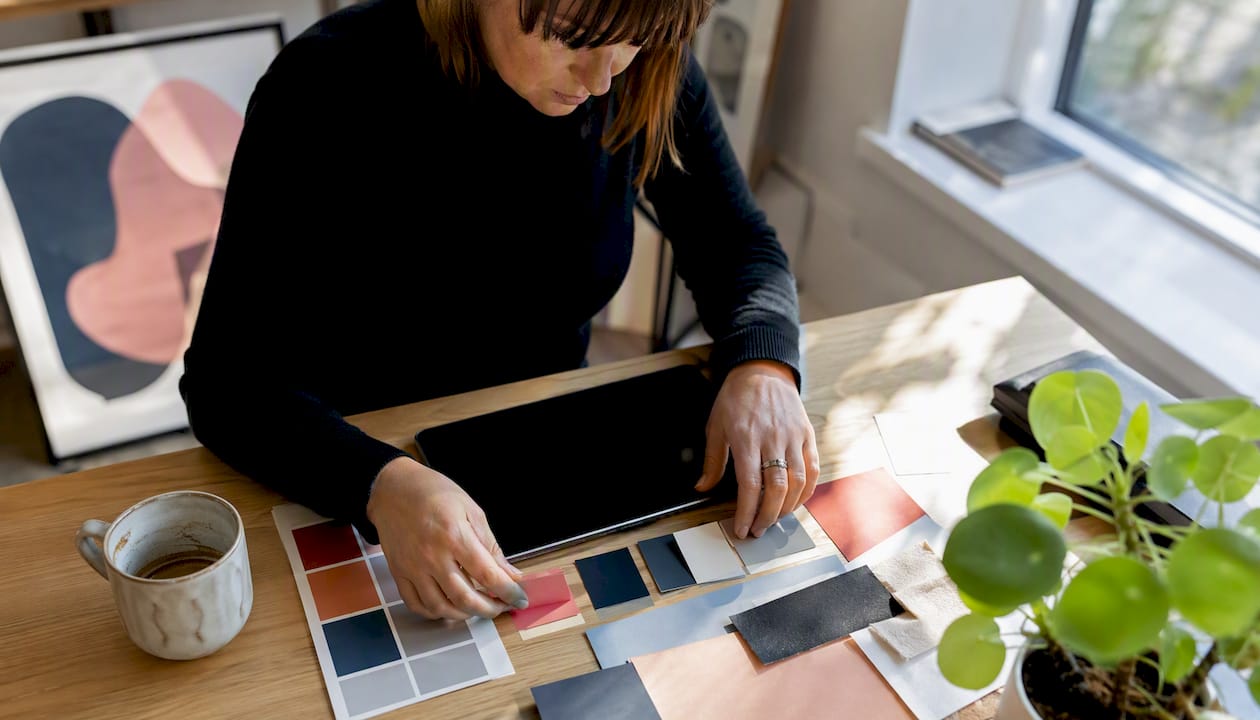 Hands using tablet with branding swatches