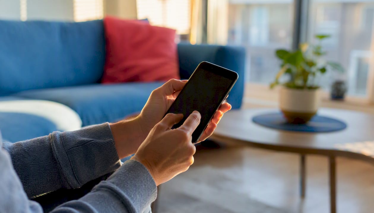 Hands arranging video clips on smartphone timeline