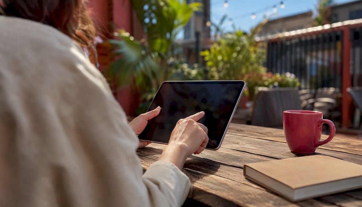 Hands adjusting marketing assets on tablet