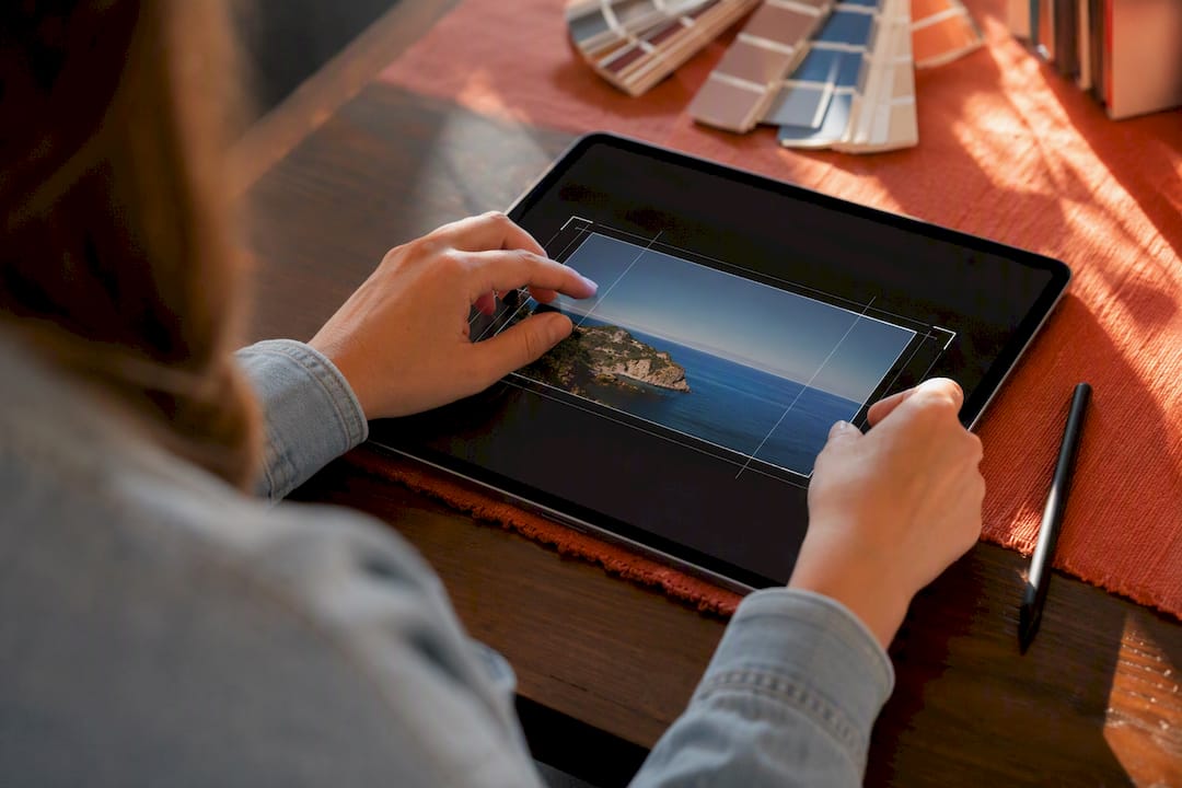 Hands centering photo on tablet screen