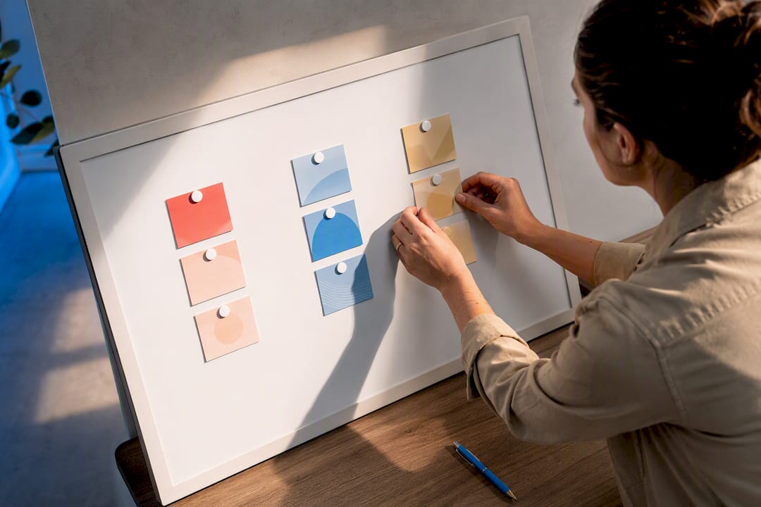 Hands organizing color-coded content pillar tiles